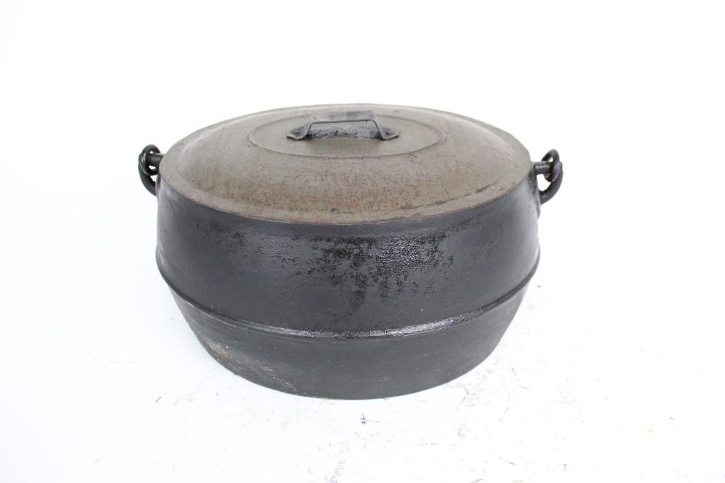 Antique Marietta & Co Cast Iron Dutch Oven with Handle: Antique Marietta & Co cast iron dutch oven with handle. This piece has gate mark on the bottom. It was produced in Marietta, PA. It is complete with a grate inside. The dimensions are 8in x 14.25in x