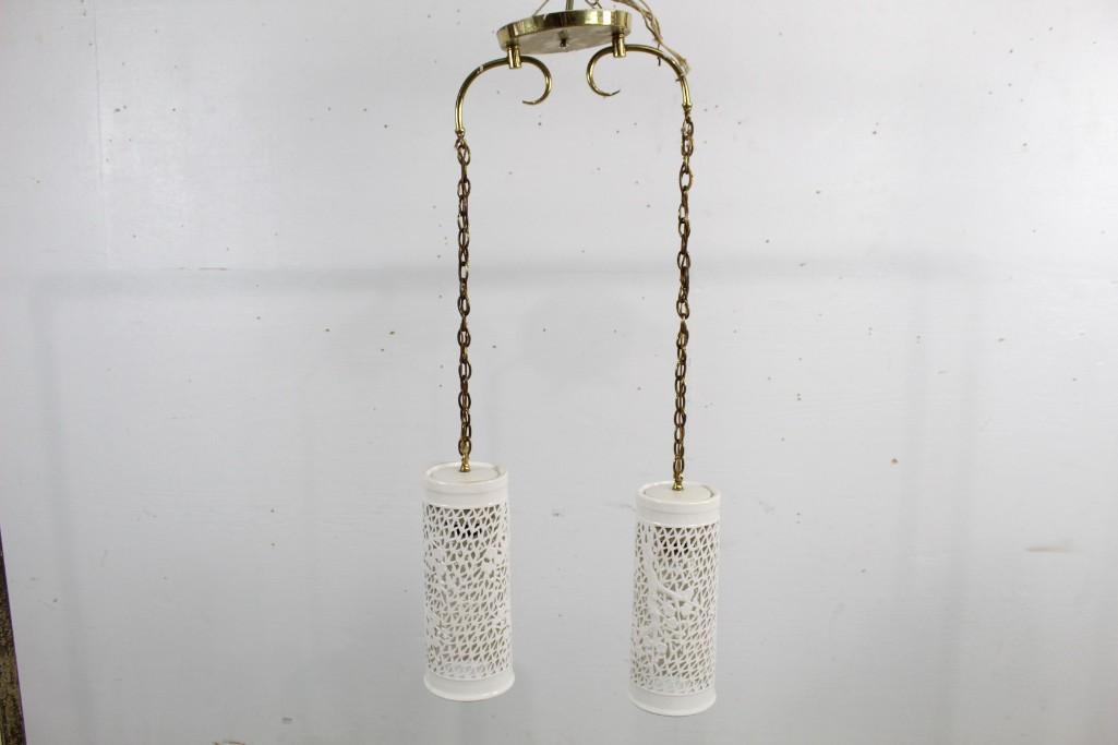 Mid-century Modern White Hanging Ceramic Light Fixture: Mid-century Modern white hanging ceramic light fixture, with tree branch motifs cutout. These would look well in a kitchen or common space. The dimensions are 35 in h x 16 in w x 7 in d. Condition is 