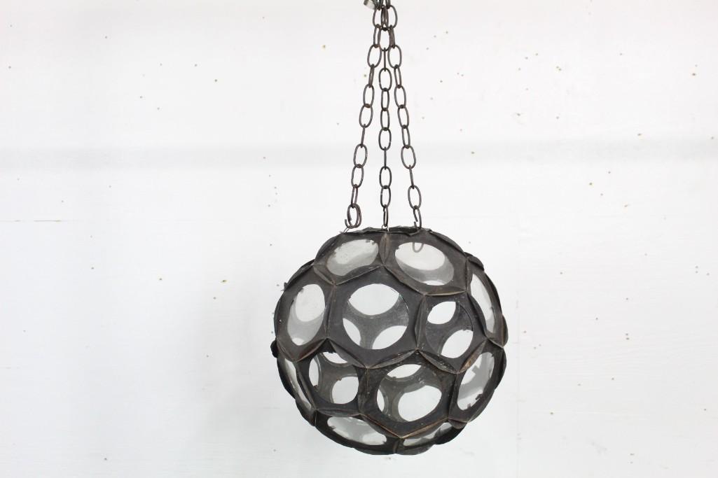 Faceted Metal & Glass Circular Hanging Lantern: Faceted Metal & glass circular hanging lantern. This piece would look great in a kitchen or industrial setting. Dimensions are 29 in h x 14 in w x 14 in d. Condition is good, with some light wear on s