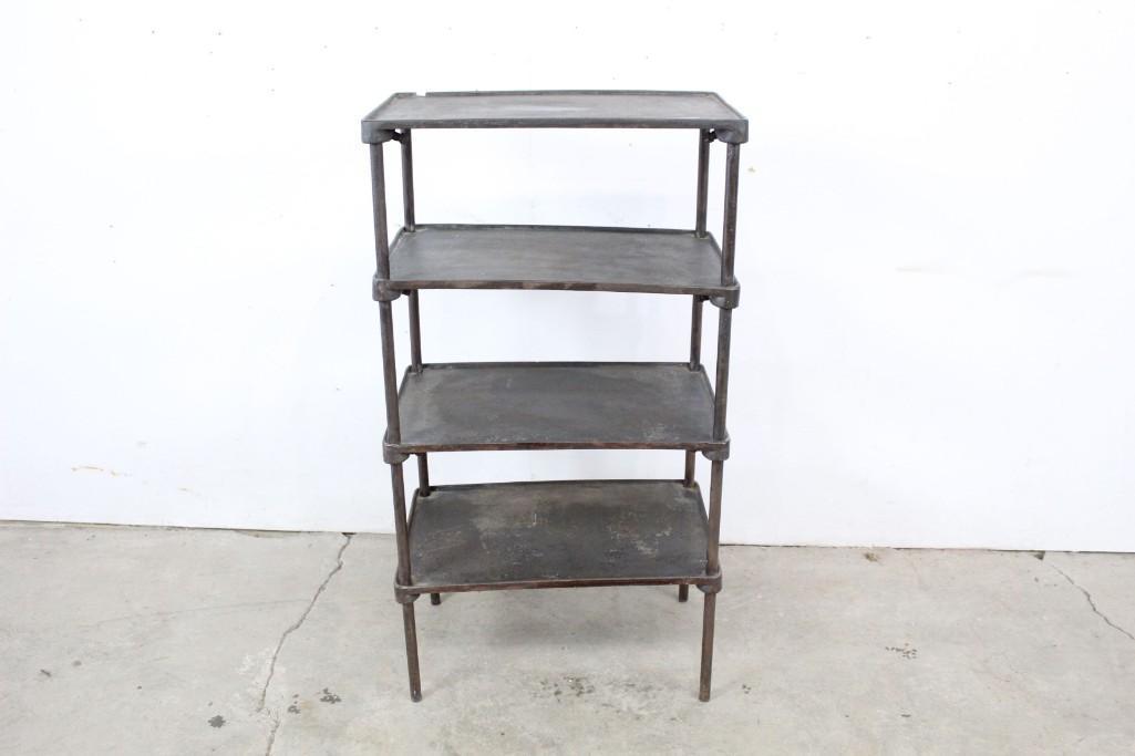 Early American Industrial Cast Iron Shelf New Britain: An early American industrial cast iron 4-tiered shelving unit made by "New Britain Machine Co." of Connecticut. This solid piece has four decks with raised edges that function somewhat like trays to k