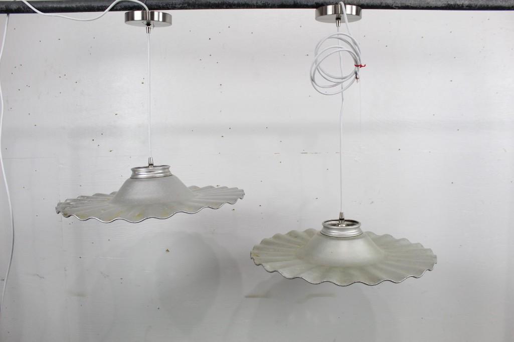 Industrial Metal Pair of Ruffled Hanging Lights/Shades: Pair of ruffeled Metal Hanging light/shades. With industrial accents, these lights would be great for a bar or kitchen. The dimensions are 20.5in h x 20.5in w. Condition is good, with discoloration an