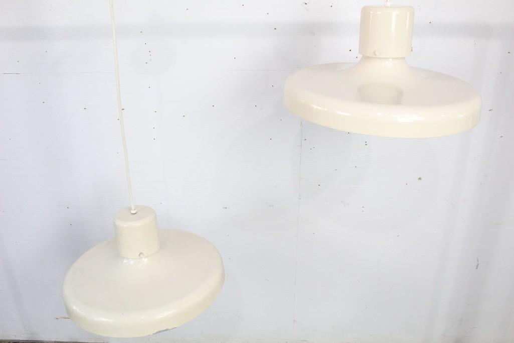 Mid-century Modern Pair of Cream Enamel Hanging Lights: Mid-century Modern pair of cream enamel hanging lights. This pair would look great in a kitchen or bar setting. Dimensions are 31 in h x 17 in w x 17 in d. Condition is fair, with paint loss and chipp