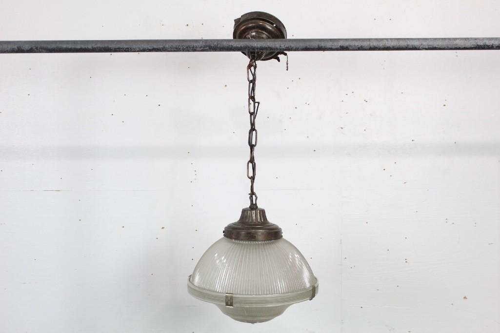 Industrial Holophane Glass/Metal Hanging Light Fixture: Holophane glass & metal hanging light fixture. This piece would bring an industrial feel to any room. Dimensions are 33.5 in h x 13.5 in w x 13.5 in d. Condition is good, with slight wear to the surfa