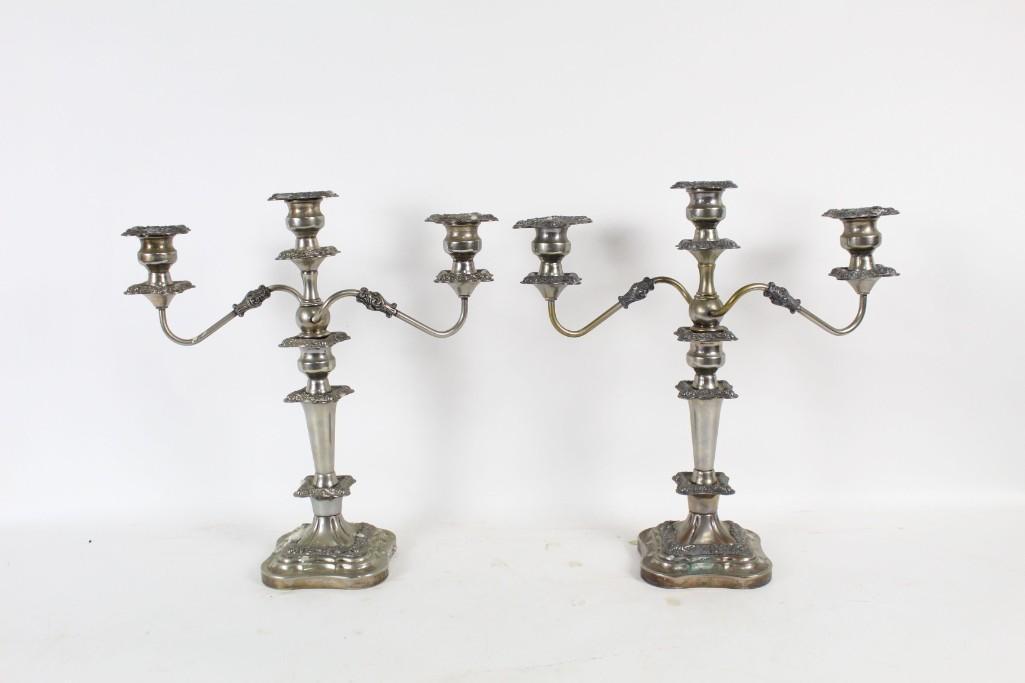 Pair Antique Silver Plated Candelabra Candle Holders: Pair of Antique Silver Plated Candelabra, each with 2 curvy spinning arms. Ornately decorated, they would add a dramatic touch to your Victorian dining table. The dimensions are 18 in h x 16.5 in w x