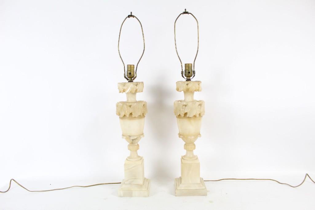 Pair Antique Classical Carved Marble Lamps Lighting: Matching pair of antique carved marble lamps, in a classical style with 2 tiers of grape leaf decoration on an urn, sitting on a pedestal. Carved marble is light colored and the overall feel is refine