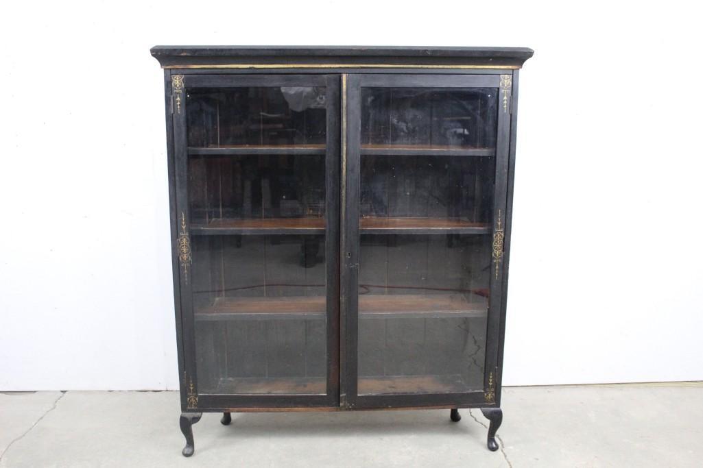 Ebonized Wood & Gilt Decorated Glass Front Bookcase: Ebonized Wood & Gilt Decorated Glass Front Bookcase. This beautiful bookcase has fine, ornate gold details and designs on it. The designs are in the eastlake victorian style. This is the perfect place