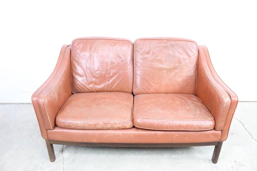 Mid-century modern Danish Leather Love Seat Sofa: Danish modern brown leather love seat. The wear that gives it character suggests it was well-loved, and is ready to be loved again by someone new. This piece is unusually lightweight, making it easy t