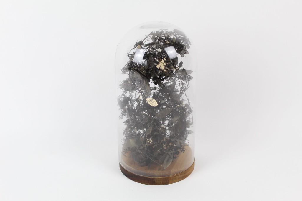MoMA Collection Piece,Black Metal Plant Terrarium: MoMA Collection Piece,Black Metal Plant Terrarium. This bold piece exhibits a terrarium with plants formed out of black metal. The plants rest inside a glass dome and sit on top a wooden base. This pi