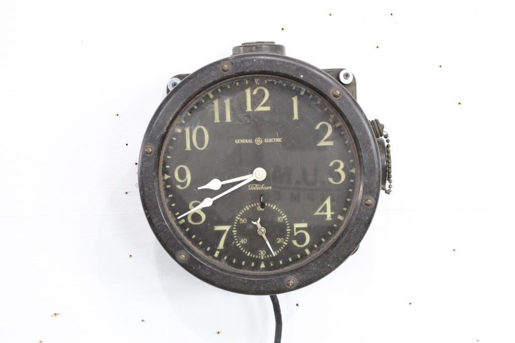 Antique Black General Electric-Telechron Clock: Antique black General Electric-Telechron clock. This classic piece would look great on the wall of a study or industrial setting. Dimensions are 10 in h x 10 in w x 6.5 in d. Condition is fair, with s