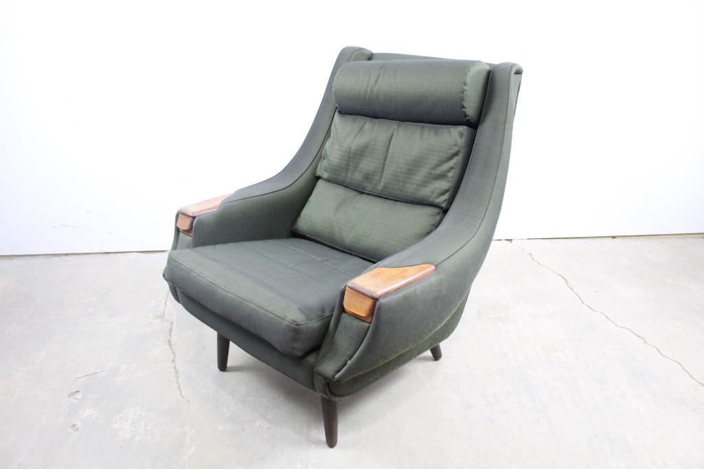 Danish Mid-century Modern Green Upholstery Lounge Chair: Danish Mid-century Modern green upholstery lounge chair. This dark green lounge chair is the perfect place to recline in style. It also has a fun hidden compartment in the arm rest. The dimensions are