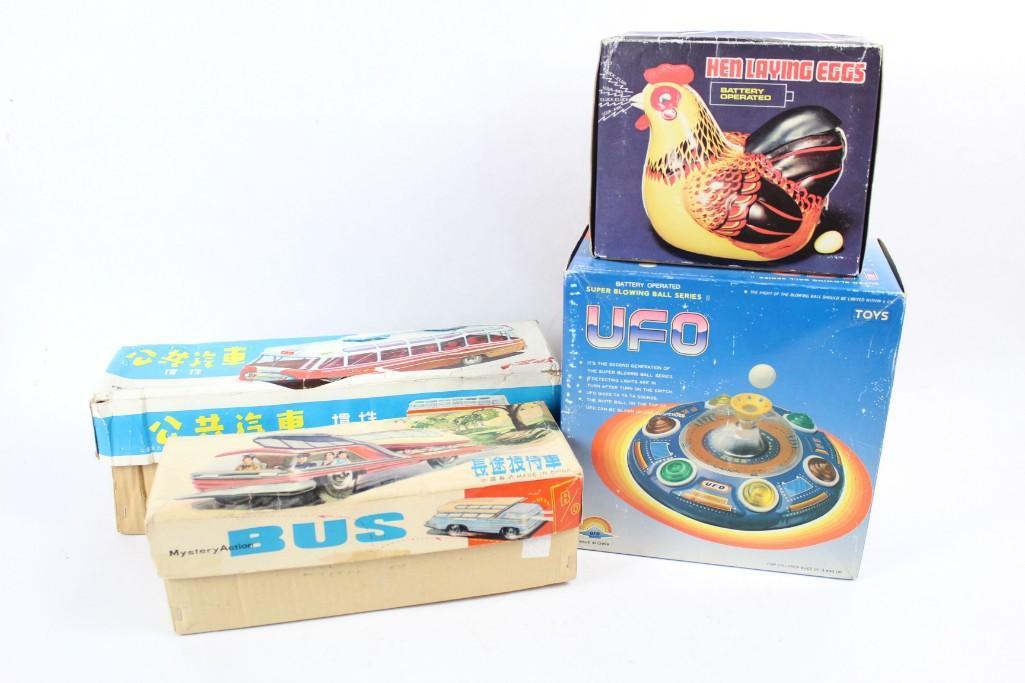 Mid-century Chinese Tin Toys Lot in Boxes Bus Hen UFO: Lot of four different Chinese toys from the mid-century modern era, in boxes with delighful labeling. Includes a battery-operated "Hen Laying Eggs," a UFO from the "Super Blowing Ball Series II" that