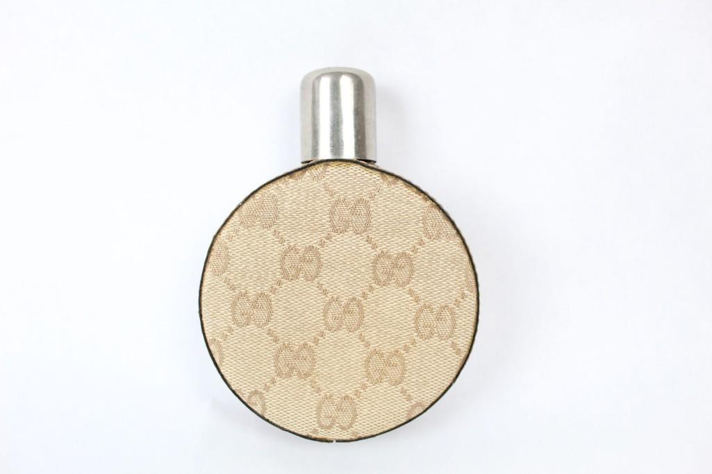 Gucci Round Monogram Logo Glass Leather Flask Barware: Vintage round flask with the iconic Gucci "Double G" monogram in brown fabric with leather sides and metal cap. Side is marked "Made in Italy" and "Gucci" in faded lettering. Whatever you're drinking