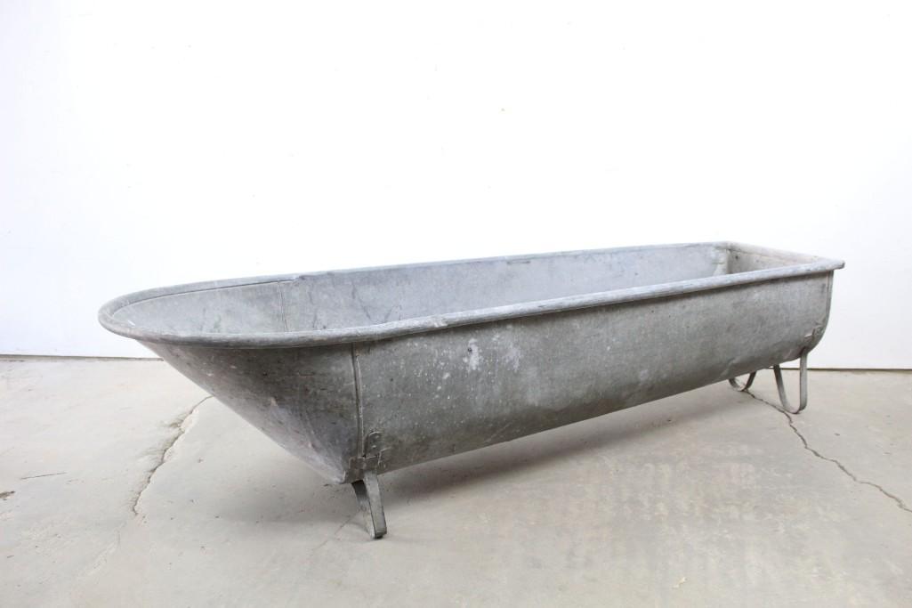 Industrial Galvanized Bathtub Wash Basin Planter: Industrial galvanized metal bathtub or wash basin, with legs allowing it to be freestanding. Could also be used as a watering or feeding trough or an attractive garden planter. Dimensions are 18 in h 