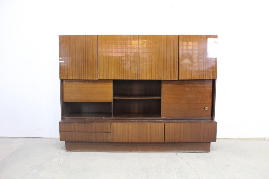 Mobelfabrik Mid-century Modern German Mahogany Cabinet: Mobelfabrik Mid-century Modern German two piece cupboard. This piece has a lock, key, and brass knobs. It has a great Mid-century Modern look with lots of compartments for storage. This piece has a st