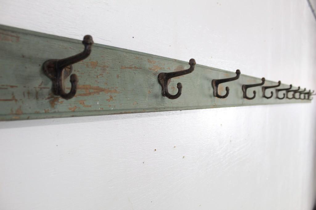 Long Industrial Factory Green Wooden Coat Hook Rack: Long Industrial Factory Green Wooden Coat Hook Rack. Featuring a distressed patina, this would go well in a coat room or entry space. The dimensions are 142.25 in h x 5 in w. Condition is good, with s