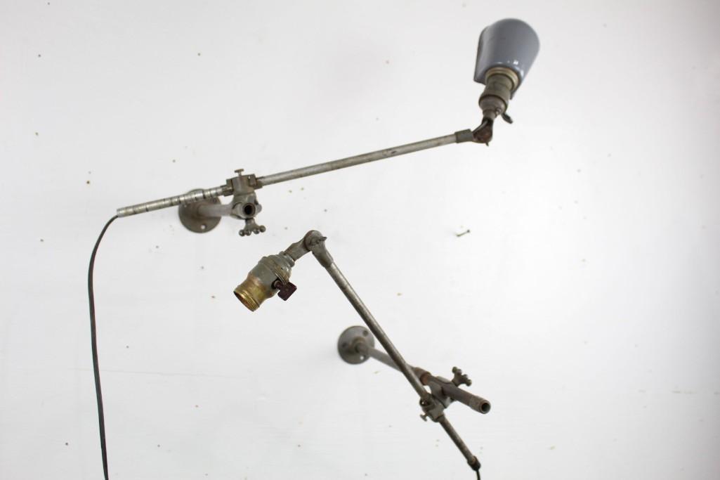 Pair Industrial Factory O.C. White Wall Mounted Lamps: Pair of Industrial Factory Adjustable Wall Mounted Lamps. One has an enameled gray shade, and they both have nice patina. Wonderful for adding light to a workspace or in a commercial setting. Dimensio