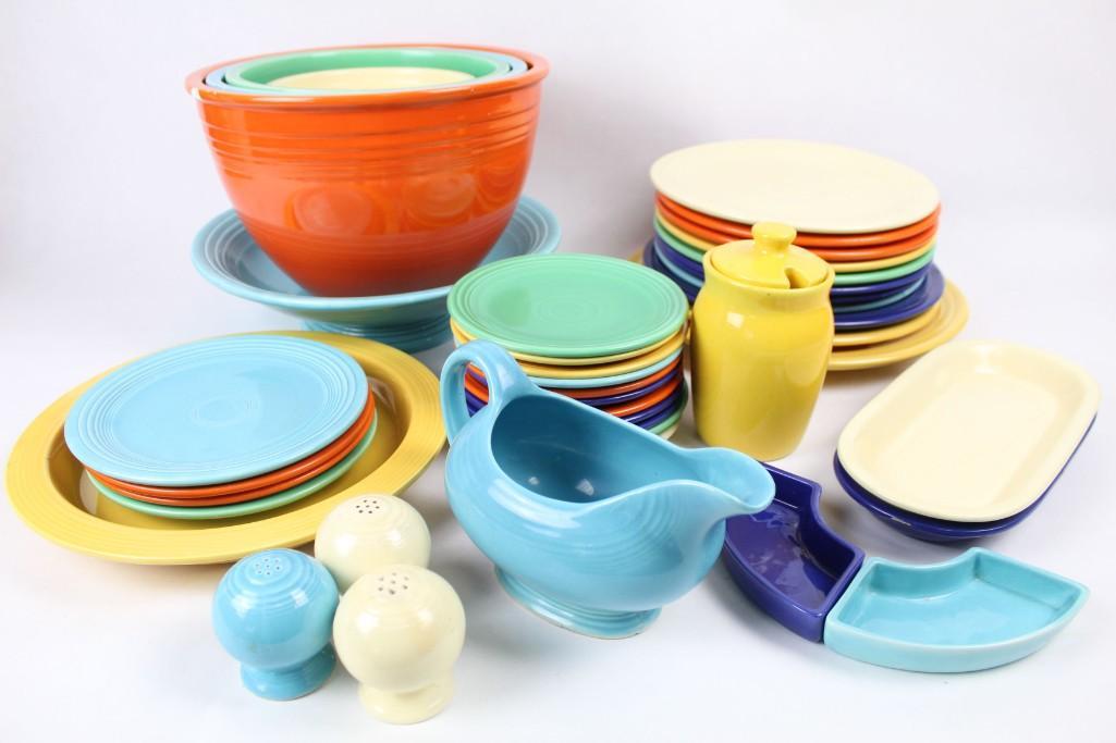 Lot of Fiestaware & Serveware, Fiesta, Homer Laughlin: Multicolored set of 4 mixing bowls, 11 saucers, 10 dinner plates, 4 side plates, 2 large serving plates, 1 serving bowl, 1 gravy boat, 1 sugar jar, 3 salt & pepper shakers, 2 small bread trays and 2 s