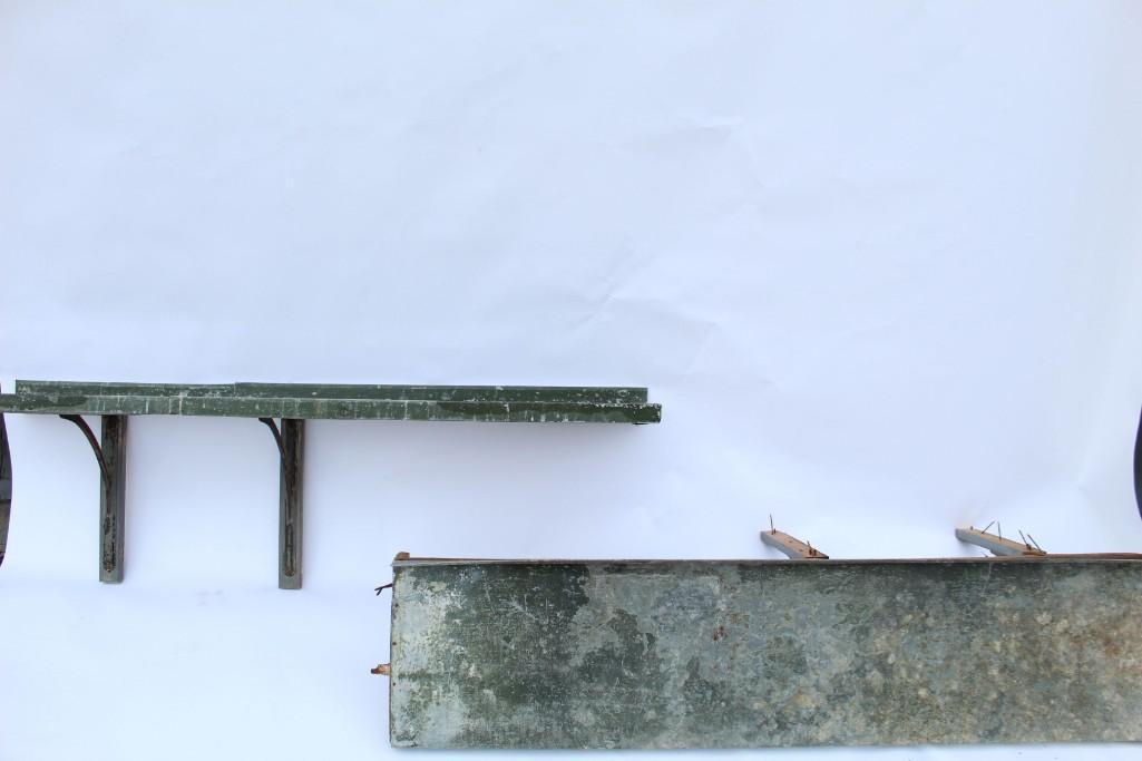 Set of Two Green Painted Metal Surfaced Wooden Shelves: Set of two green painted metal surfaced wooden shelves, with two metal mounting brackets on each. Paint on metal shows amazing patina and character. Companion to two longer shelves in another lot in t