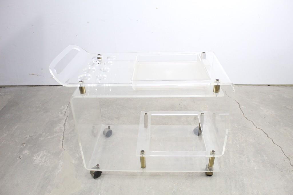 Mid-Century Modern Lucite Rolling Bar Cart: Stylish mod vintage Lucite rolling bar cart with brass. This cool Lucite bar cart is the perfect place for mixing cocktails and serving drinks. It has holes for storing bottles and a removable tray. T