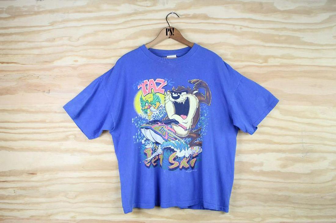 Blue Large Taz Jet Ski Vintage Warner Bros T-Shirt 1991: SHIPPING: We will ship this item in-house, for a $12 flat rate to the Continental US; $2 for each additional shirt. Please contact us for a shipping quote on larger quantities. Blue Large Taz Jet Ski 