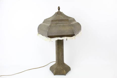 Antique Brass Filigree Table Lamp,Middle Eastern: Ornate brass filigree lamp with fabric trim on shade, featuring a hexagon shaped shade and base. This piece would compliment a living room or study well. Dimensions are 23.5 in h x 13 in w x 13