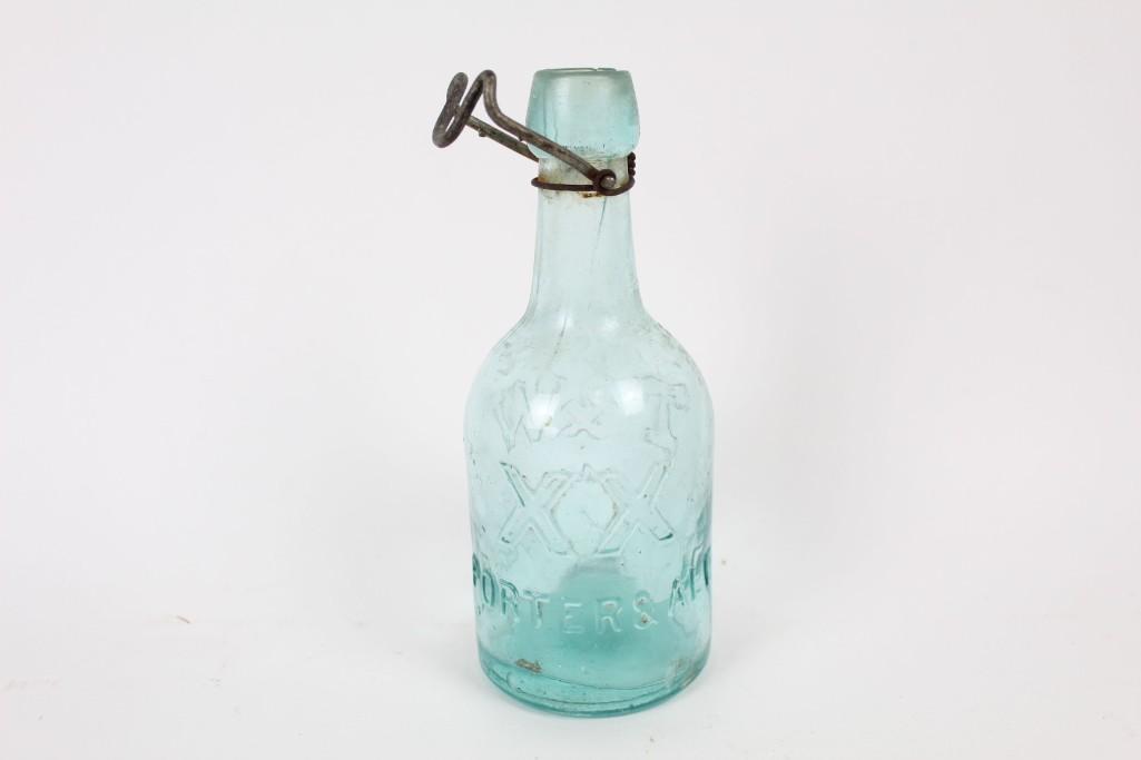 Antique Aqua T&W N.Y. Squat Porter & Ale Glass Bottle: Antique Aqua T&W N.Y. Squat Porter & Ale Glass Bottle. Squat and outfitted with the metal hardware to keep a top in place, this beautifully colored beer bottle displays "114 Franklin St. N.Y." embosse