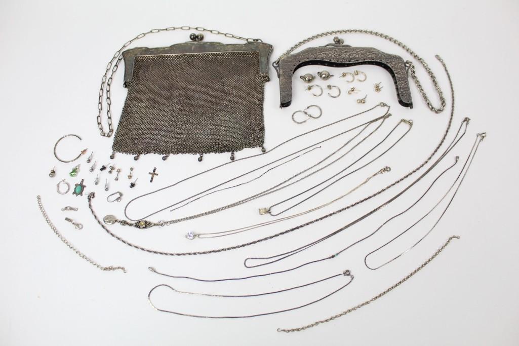 Lot of Silver Jewelry, Charms, Chain Mail Purse: Lot of silver jewelry, featuring charms, a chain mail purse dated 1909, and chains/necklaces. A great addition to any jewelry collection. Dimensions range from .05 in h to 15.25 in h. Condition is goo
