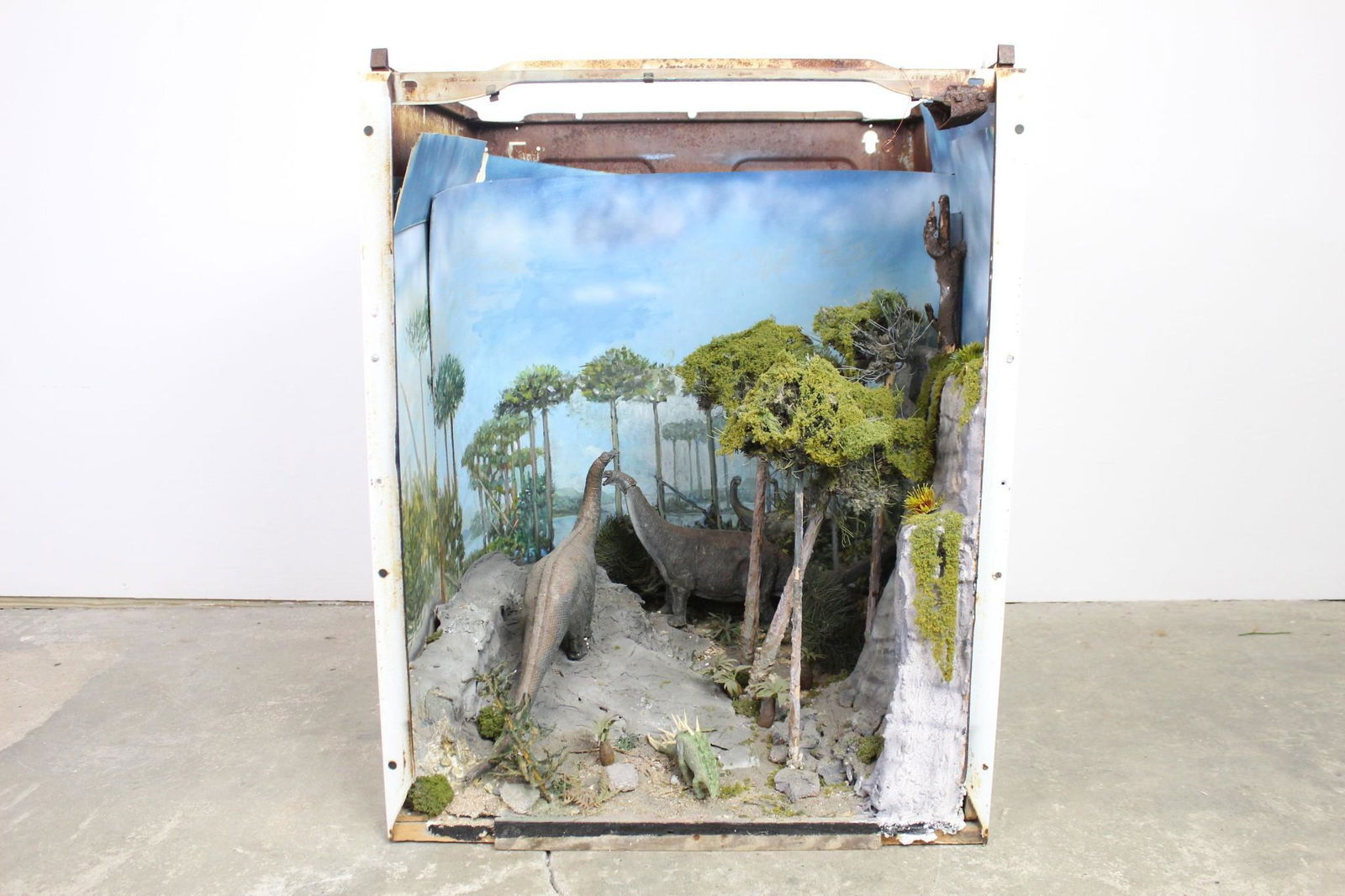 Folk Art Dinosaur Brontosaurus Diorama Children Museum: Folk Art Dinosaur Brontosaurus Diorama Children Museum. This is a fun diorama of 2 brontosaurus' walking in the forest that was made inside of an old washing machine or dryer. It has a painted cur