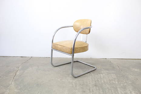 Mid-Century Modern Anton Lorenz Style Tubular Armchair: Mid-Century Modern Anton Lorenz Style Tubular Armchair. This is a wonderful Mid-century Modern armchair in the style of Anton Lorenz. It has a curved, tubular, chrome frame with cream colored vinyl up