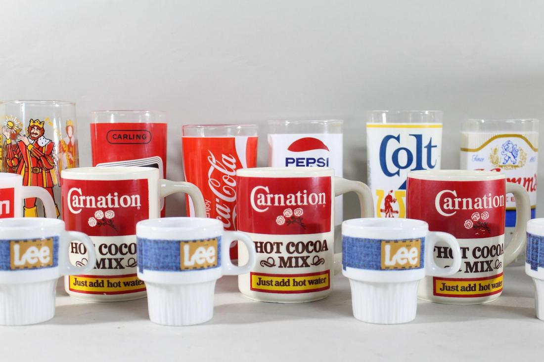 38 Pc Branded Kitchenware, Coca Cola, Campbells & More: 38 Pc Branded Kitchenware, Coca Cola, Campbells & More. This is a lot of various branded kitchenware items, including mugs, saucers, and drinking glasses, as well as a few additional novelty items. Th