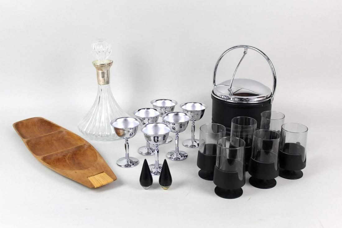 17 Piece Mid-Century Modern Serveware & Barware Lot: 17 Piece Lot of Mid Century Modern Serveware. Bold black ice bucket and six silver metal insulated stemmed wine glasses. Long wood serving tray perfect to house the cocktail garnishes on your bar. Set
