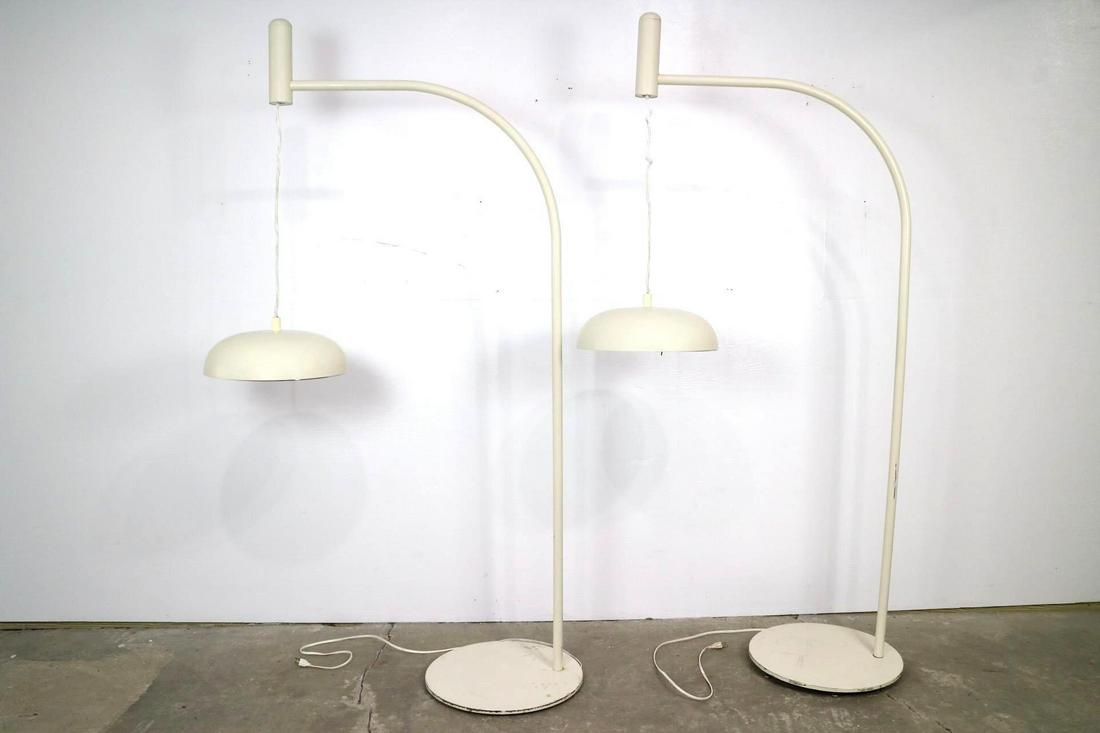 Pair Mid-Century Modern Arc Industrial Floor Lamps (B): Pair Mid-Century Modern Arc Industrial Floor Lamps (B). This is a pair of white Mid-century modern industrial floor lamps. These large off-white curved floor lamps have a circular base and circular la