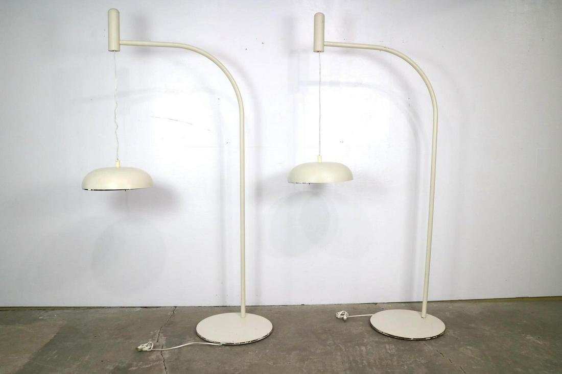 Pair Mid-Century Modern Arc Industrial Floor Lamps (D): Pair Mid-Century Modern Arc Industrial Floor Lamps (D). This is a pair of white Mid-century modern industrial floor lamps. These large off-white curved floor lamps have a circular base and circular la