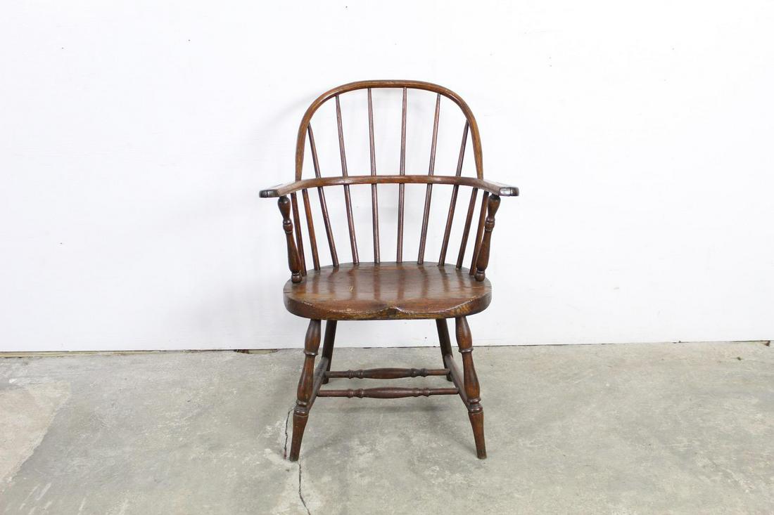 Rounded Turned Wooden Windsor Barrel Arm Dining Chair: Rounded Turned Wooden Windsor Barrel Arm Dining Chair. This is a handsome windsor chair with vertical back slats, armrests, and turned wooden legs. It is made of a darker wood with a beautiful grain.