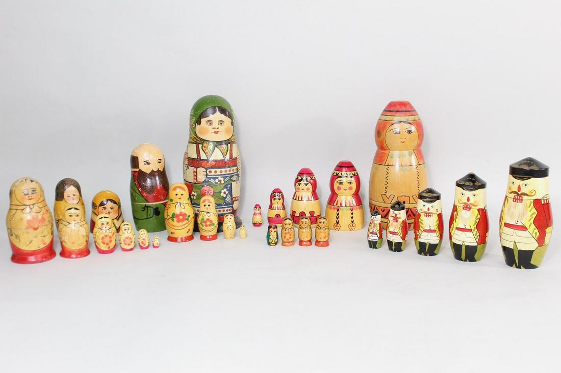 Lot of 5 Hand Painted Russian Matryoshka Nesting Dolls: Collection of hand painted matryoshka dolls, featuring five nesting dolls and a few assorted individual pieces, for a total of 29 different pieces. Includes a nutcracker figure, traditional matron fig