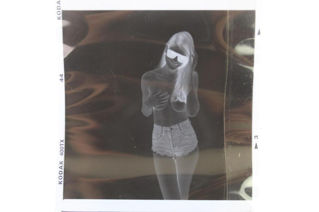 Jonathan Leder: Roll of 7 Photographic Negatives,Nudes: Jonathan Leder: Roll of 7 Photographic Negatives,Nudes. A roll of seven negatives of a topless woman wearing shorts and sunglasses by Jonathan Leder. Dimensions are 33.5 in h x 2.5 in w. Condition is 