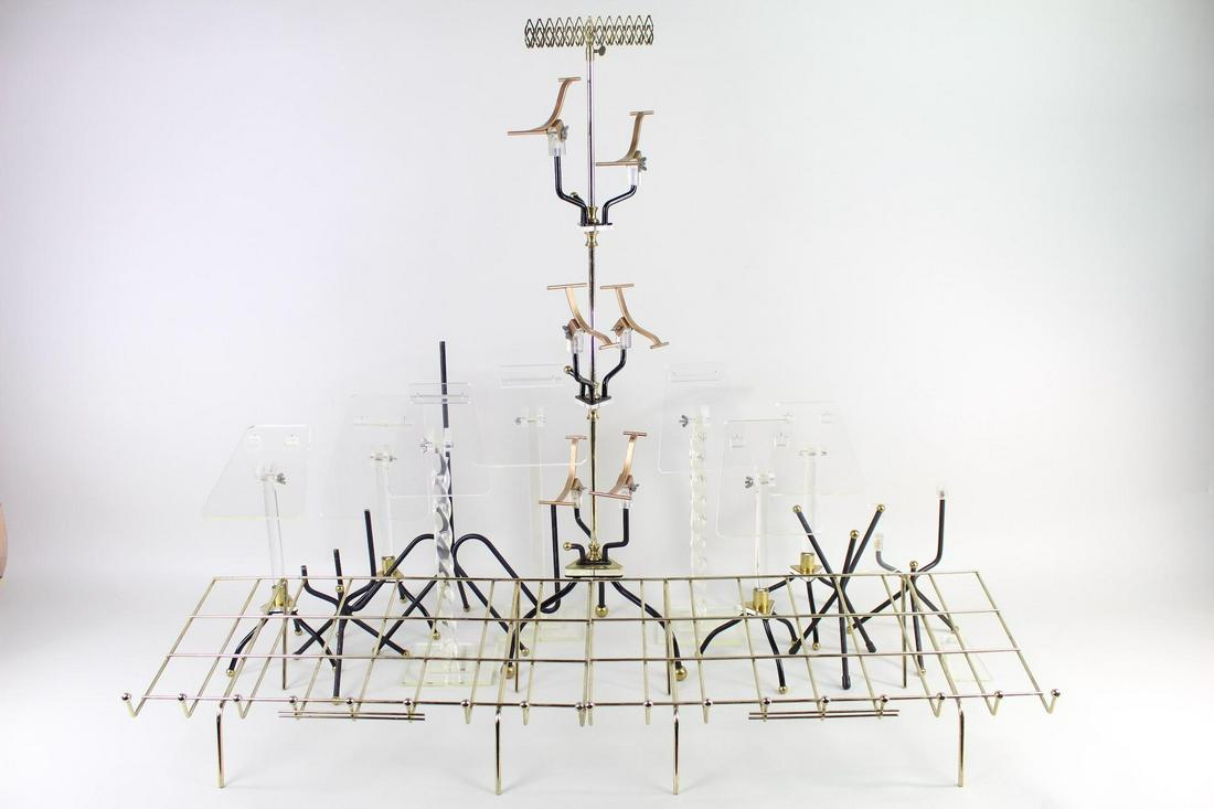 Collection of 12 Shoe Display Stands Metal Brass Lucite: Collection of 12 Shoe Display Stands Metal Brass Lucite. These shoe stands, in a variety of styles, shapes, and materials, are united by their purpose-built design and craftsmanship, making an excelle