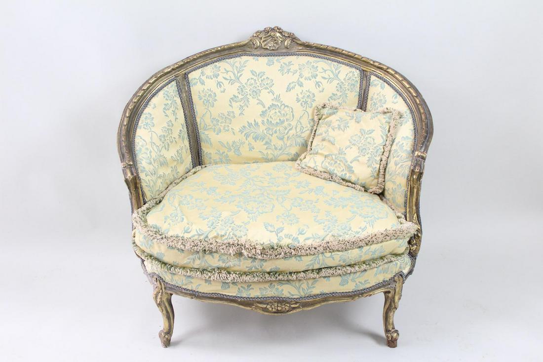 Oversize French Gold Louis XVI Style Bergere Chair: Oversize French Gold Louis XVI Style Bergere Chair. Wide French style chair has a gold finished carved wood frame, and is upholstered in cream with floral blue embroidery and fringe. Elegant seat for 