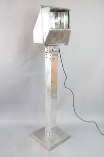 Large Industrial Chrome Wide-Lite Floodlight Floor Lamp: Large Industrial Chrome Wide-lite Floodlight Floor Lamp. This is a fantastic industrial chrome floodlight. It has a square base and stem with reflective strips curved around the socket. The head of th