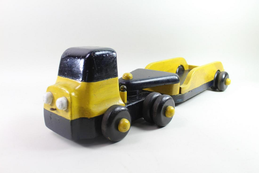 Mid-Century Modern Wooden Black & Yellow Wood Truck Pull Toy: Mid-Century Black & Bright Yellow Wood Truck Pull Toy. Completely handmade of wood, including the tires with a NY 52 license plate is attached to the back of the cab.Dimensions are 7.5 in h x 10 in w