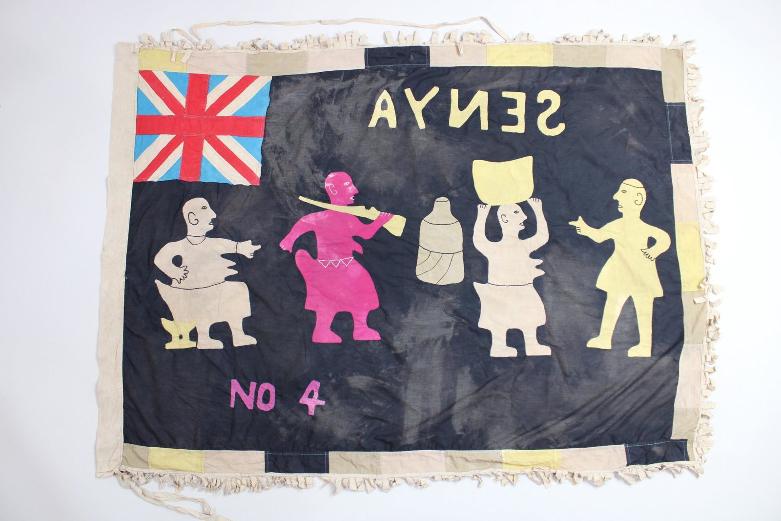 Fante Asafo Flag, Figures with Rifle, Stool, Senya, Early-Mid 20th C. Ghana, 86 of 107: Fante Asafo Flag #86 depicts four figures in various colors, some pointing, seated, or carrying rifle or jar, over black ground, with Union Jack flag canton, and border of black, yellow, and tans stri