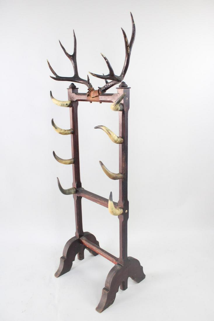 Floor Standing Bull Horn & Antler Mounted Hat Coat Gun Rack: Floor Standing Bull Horn & Antler Mounted Gun Hat Coat Rack. Stunning handmade freestanding rack has eight bull horns culminating in an impressive deer antler spread on top. Dark painted wood frame wi