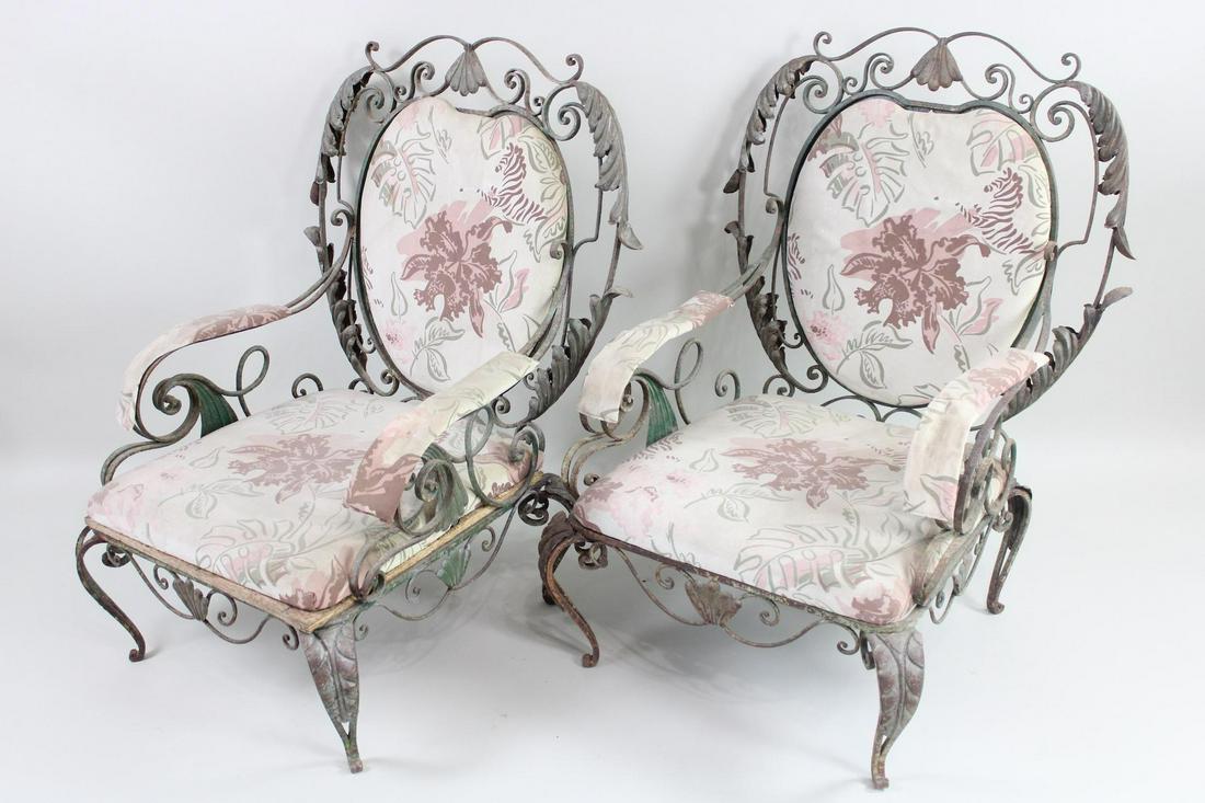 Pair of Victorian Wrought Iron Patio Chairs: Pair of Victorian Wrought Iron Patio Chairs. This is a fantastic pair of Victorian lounge chairs. It has pink floral upholstery and an organic, Art Nouveau style metal frame. Dimensions are 38 in h x 