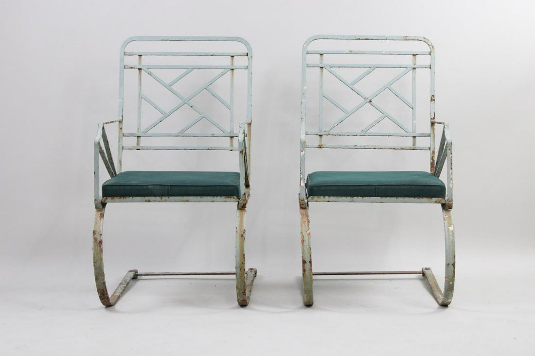 Pair of Chinese Chippendale Iron Outdoor Patio Springer Chairs: Pair of Wrought Iron Cantilever Outdoor Patio Chairs, Green Seats. They are referred to as Chinese Chippendale Iron Outdoor Patio Chairs. Weathered painted wrought iron chairs with green fabric seat c