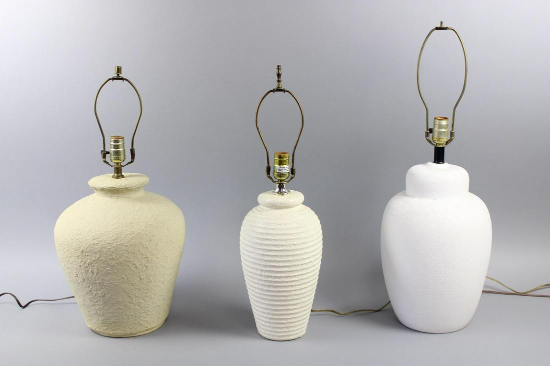 Lot of 3 Mid-Century Textured White Ceramic Lamps, Stucco: Lot of 3 Mid-Century Textured White Ceramic Lamps. Large table lamps are similar in ovoid shape but with slightly different white and off-white colors and textures: ribbed, rough texture, and smooth t