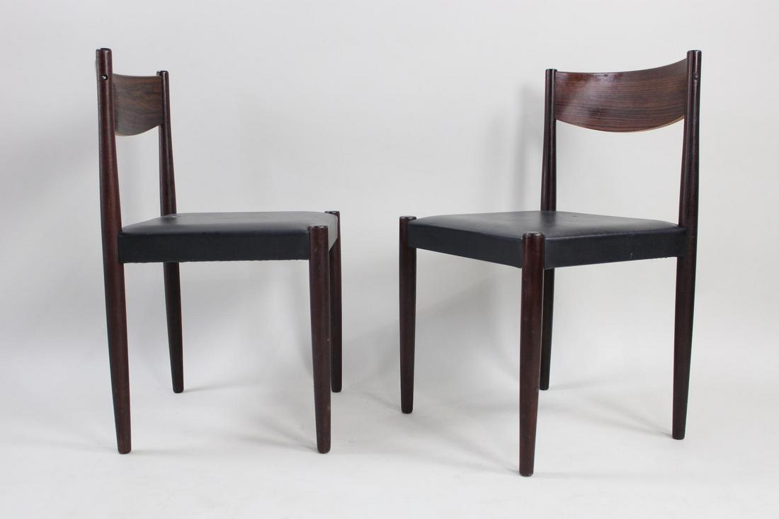 Pair of Danish Modern Frem Rojle Rosewood Dining Chairs: Pair of Danish Mid-Century Modern Frem Rojle Rosewood Dining Chairs. Matching pair of elegant chairs have rosewood frames and black vinyl seats. Marked on underside Frem Rolje and Made in Denmark. Dim