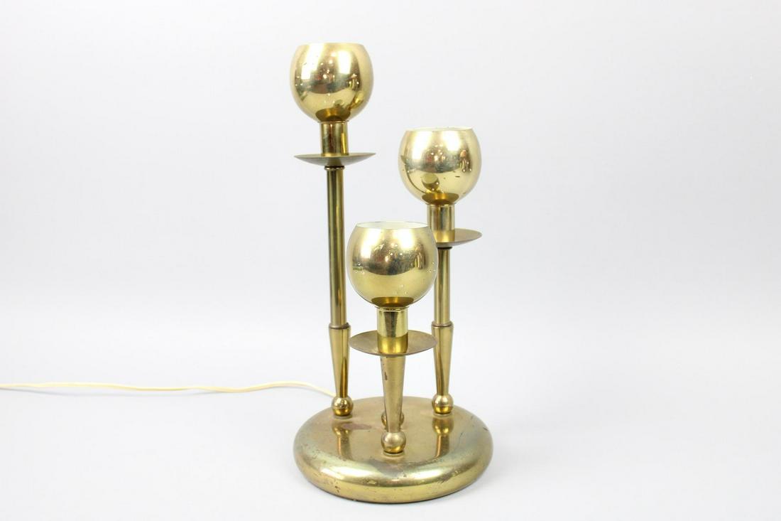 Mid Century Modern Brass 3-Arm Pierced Globe Table Lamp: Mid Century Modern Brass 3-Arm Pierced Globe Table Lamp. The Mid Century Modern brass lamp, three pierced, spherical shades on staggered height supports. The base is weighted, and the switch turns on 
