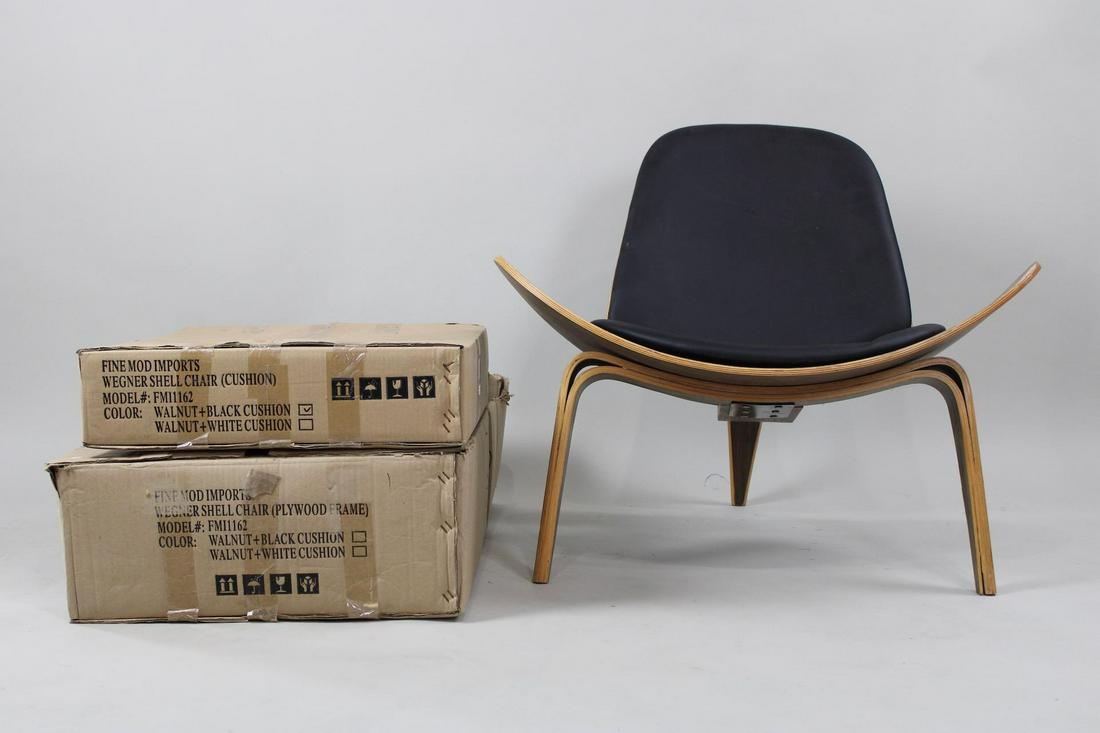 Pair of Contemporary Hans Wegner Shell Chairs, One in Box: Pair of Contemporary Hans Wegner Shell Chairs, One in Box. This is a lot of 2 chairs, one needs the cushions re-applied and one leg has wear, the other is still in the box. Dimensions are 29.5 in h x
