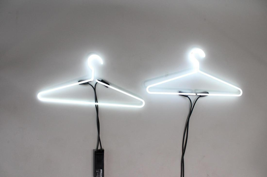 Pair of Neon Clothes Hangers, Vintage Clothing Sign: Pair of Neon Clothes Hangers, Vintage Clothing Sign. Matching pair of white clothes hanger neon lights, with Lite Brite Neon, Brooklyn NY label. Dimensions are 11 in h x 24.5 in w x 1.5 in d. Conditio
