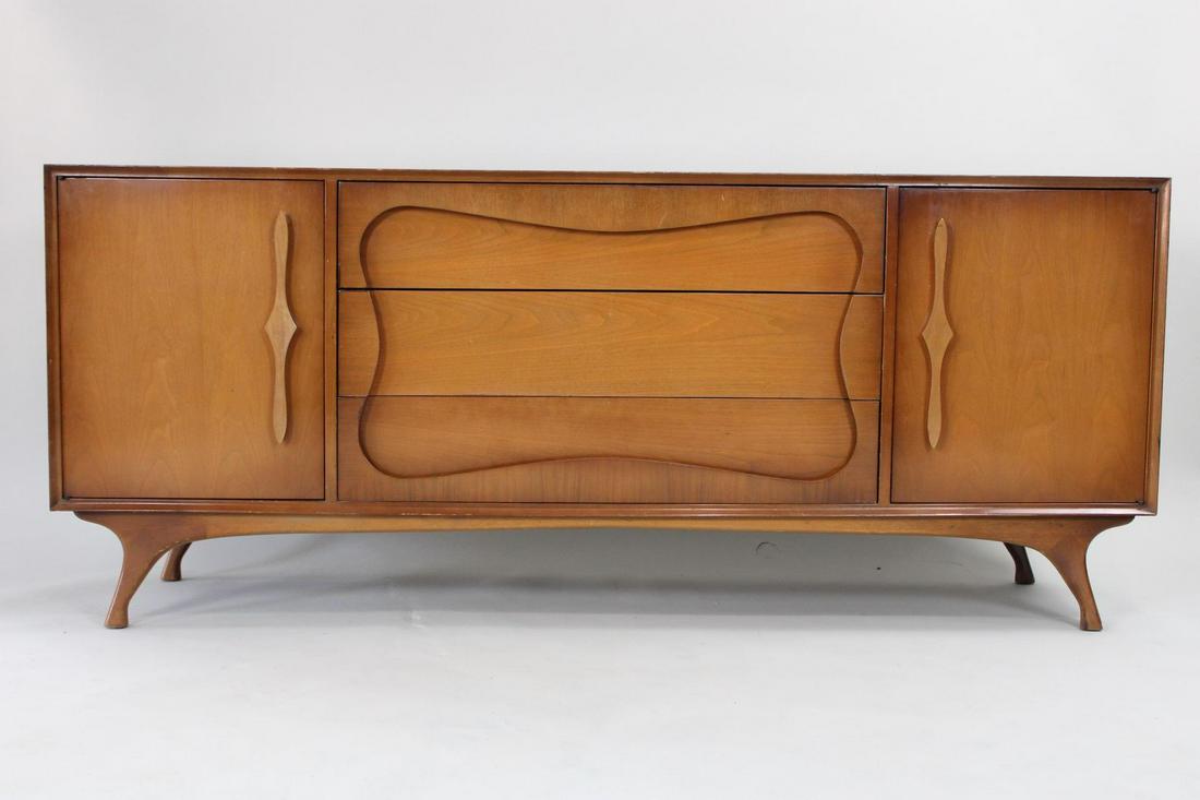 Mid Century Modern Sculptural Credenza: Mid Century Modern Sculptural Credenza. The credenza has great sculptural shaped panel and starburst shape. Dimensions are 30.5 in h x 73 in w x 19 in d. Condition is very good. Please call or email f